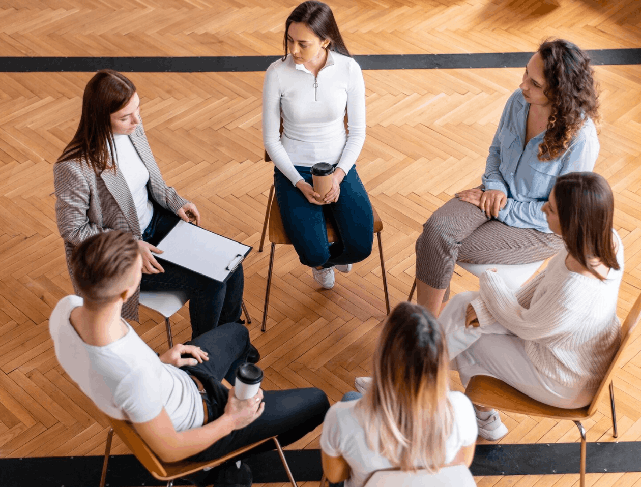 Group sitting in circle during addiction treatment session in South Carolina